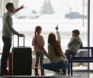 family at the aiport watching planes before travelling