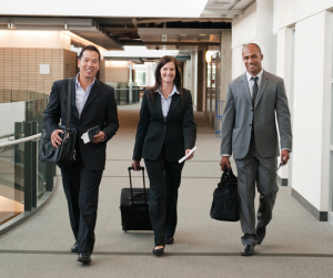 3 business people walking to go on a business trip
