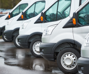 The image shows a fleet of vans that a business owns