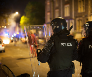 Police protecting people and buildings from rioters 