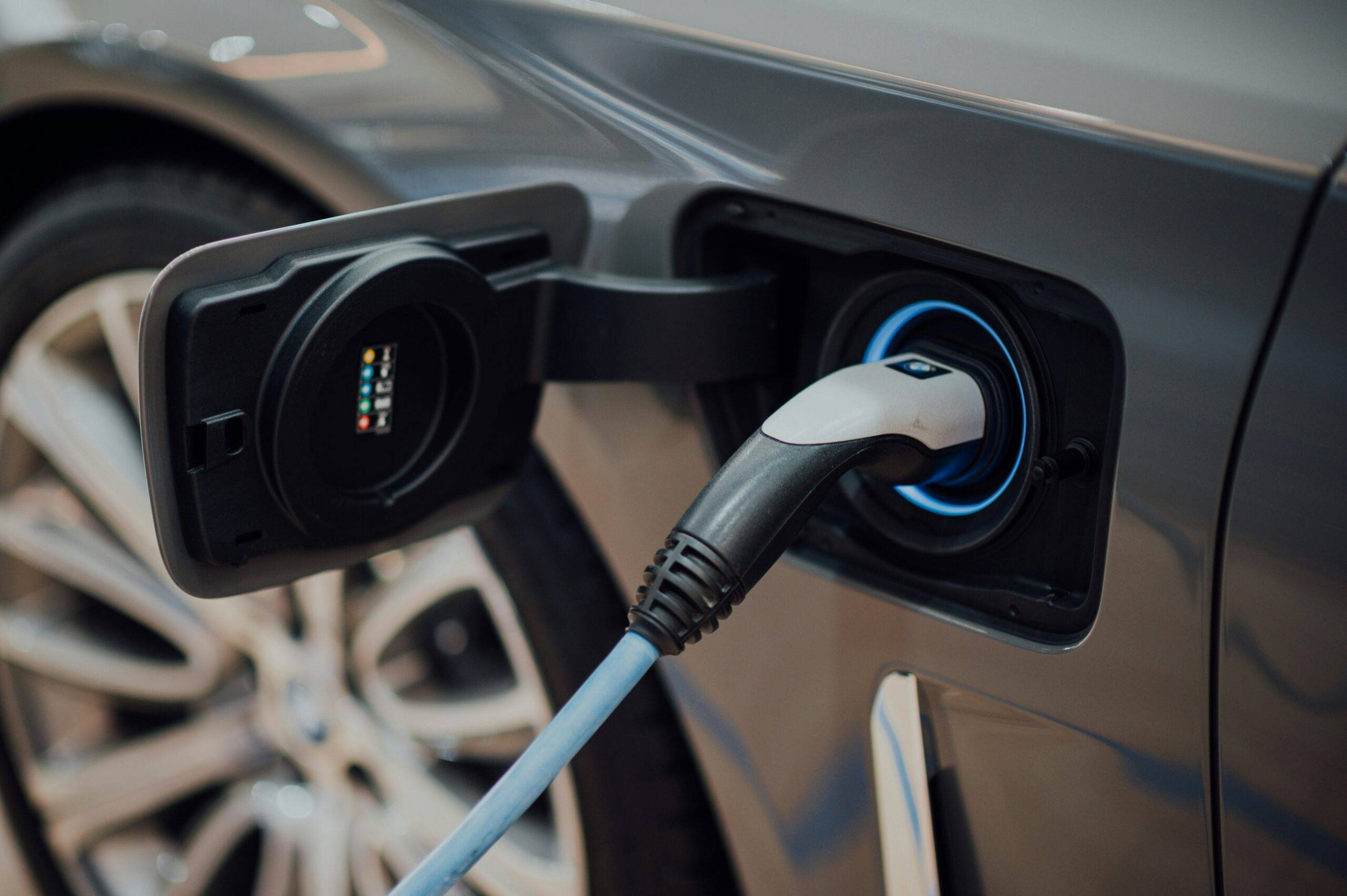 Close-up of an electric vehicle charging, relevant to GAP insurance for EV owners.